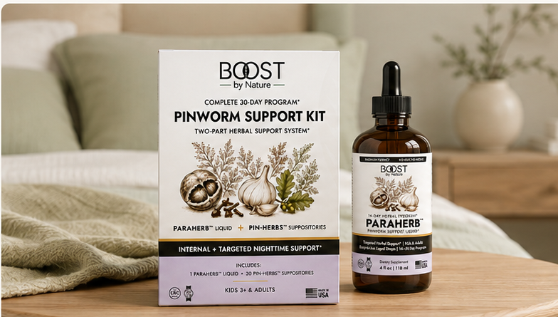 Boost by Nature Pinworm Support Kit and ParaHerb liquid on a wooden table